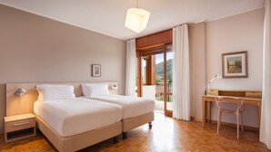 Une chambre avec deux lits, un bureau et une chaise.
