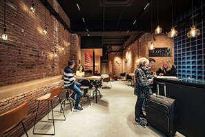 A modern interior with brick walls, hanging pendant lights, and a bar area. - Cool Jazz 52 - Habitat Apartments (Barcelona)