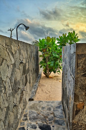 Stroll along the winding stone pathway to a serene entrance.
