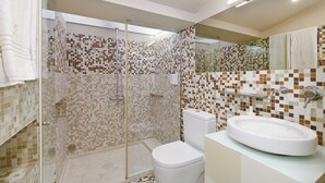 A modern bathroom with a glass-enclosed shower, a white toilet, and a large sink. - Charming Porto Apartment with City and River Views (Porto)