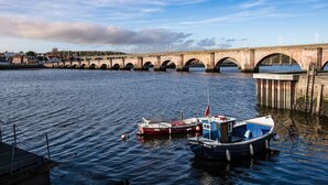 A bridge over a river with boats docked nearby. - THE MEETING HOUSE in the centre of Berwick-upon-Tweed (Berwick-upon-Tweed)