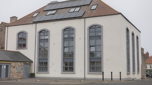 A building with large windows and a sloped roof with solar panels. - THE MEETING HOUSE in the centre of Berwick-upon-Tweed (Berwick-upon-Tweed)