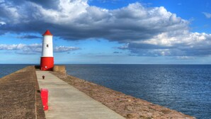 A lighthouse on a concrete pier with a view of the sea and a partly cloudy sky. - THE MEETING HOUSE in the centre of Berwick-upon-Tweed (Berwick-upon-Tweed)