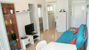 A compact hotel room with a bed, a TV, a small desk, and a wardrobe. - ROCAMAURA I B 6-1 (Estartit)