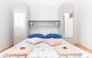 Cozy retreat with a single bed, two wardrobes, and bedside tables.