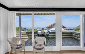 Enjoy the breathtaking sea views from this spacious balcony with a comfortable seating area.