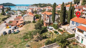 A coastal town with a marina, terraced houses, and a prominent red landmark. - Stunning home in Vrsar with WiFi (Vrsar)