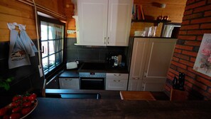 A compact kitchen with white cabinets, a toaster, and a sink. - Cozy Eifelhäuschen in the green near Nürburgring - (Hoffeld)