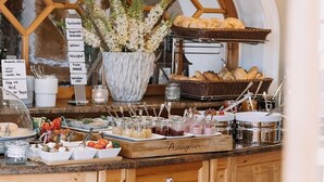 A breakfast buffet with various food items and a decorative plant.