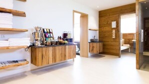 A modern kitchen with wooden cabinetry, a central island, and a view into the dining area.