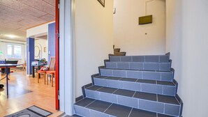 A staircase with grey steps leading to a landing.