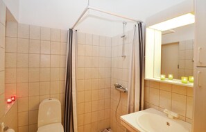 Bathroom features a shower enclosure, sink, and mirror.