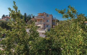 A multi-story building with balconies, surrounded by greenery. - 4 bedroom stunning apartment in Poljana (Poljana)