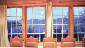 A room with large windows, wooden ceiling, and four wooden chairs. - Cozy home in Fusa with sauna (Fusa)