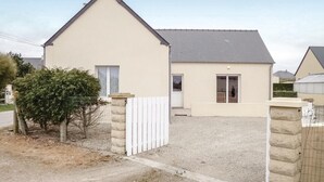 A single-story house with a sloped roof, a front door, and a small porch. - Pet friendly home in St. Marcouf De L'Isle (St. Marcouf De L'Isle)