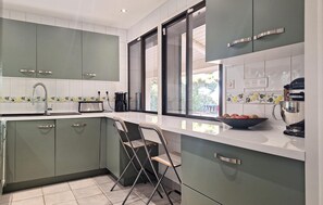 Fridge, stovetop, dishwasher, coffee/tea maker