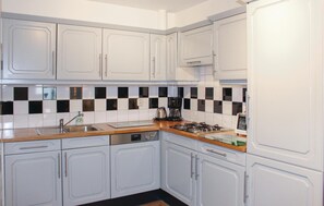 Fridge, stovetop, dishwasher, coffee/tea maker