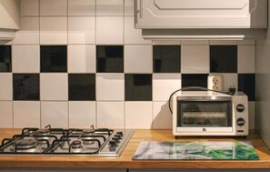 Fridge, stovetop, dishwasher, coffee/tea maker