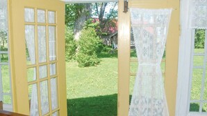 A room with a yellow door leading to a garden. - 1 bedroom amazing home in Brålanda (Brålanda)