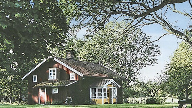 A two-story house with a sloped roof, a front porch, and a small attached garage. - 1 bedroom amazing home in Brålanda (Brålanda)