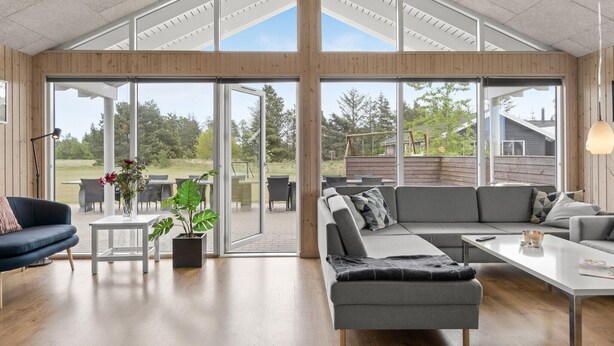 A spacious living area with a large sliding glass door leading to an outdoor patio. - Beautiful home in ålbæk with kitchen (Ålbæk)