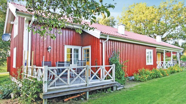 A red wooden house with a porch, a door, and a window. - 3 bedroom amazing home in Svenljunga (Svenljunga)