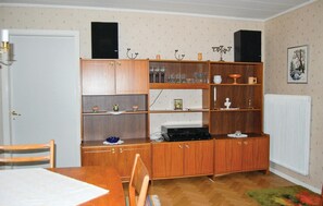 A room with a wooden cabinet, a radiator, and a framed picture on the wall. - Stunning home in östra frölunda (Östra Frölunda)