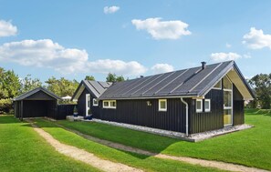 Experience the charm of this two-story building with a covered outdoor area and a wooden deck.