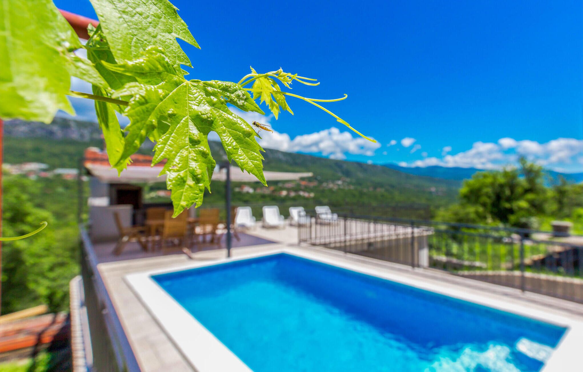 A swimming pool with a view of a mountainous landscape.