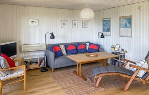 Relax in this inviting living space with a comfortable sofa, coffee table, and chair.