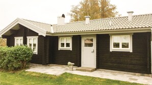 A two-story house with a dark exterior, white trim, and a tiled roof.