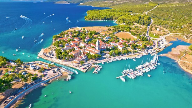 An aerial view of a coastal town with a marina, clear turquoise waters, and surrounding greenery. - Holiday apartment only 150 m to the Adriatic Sea (Mali Lošinj)