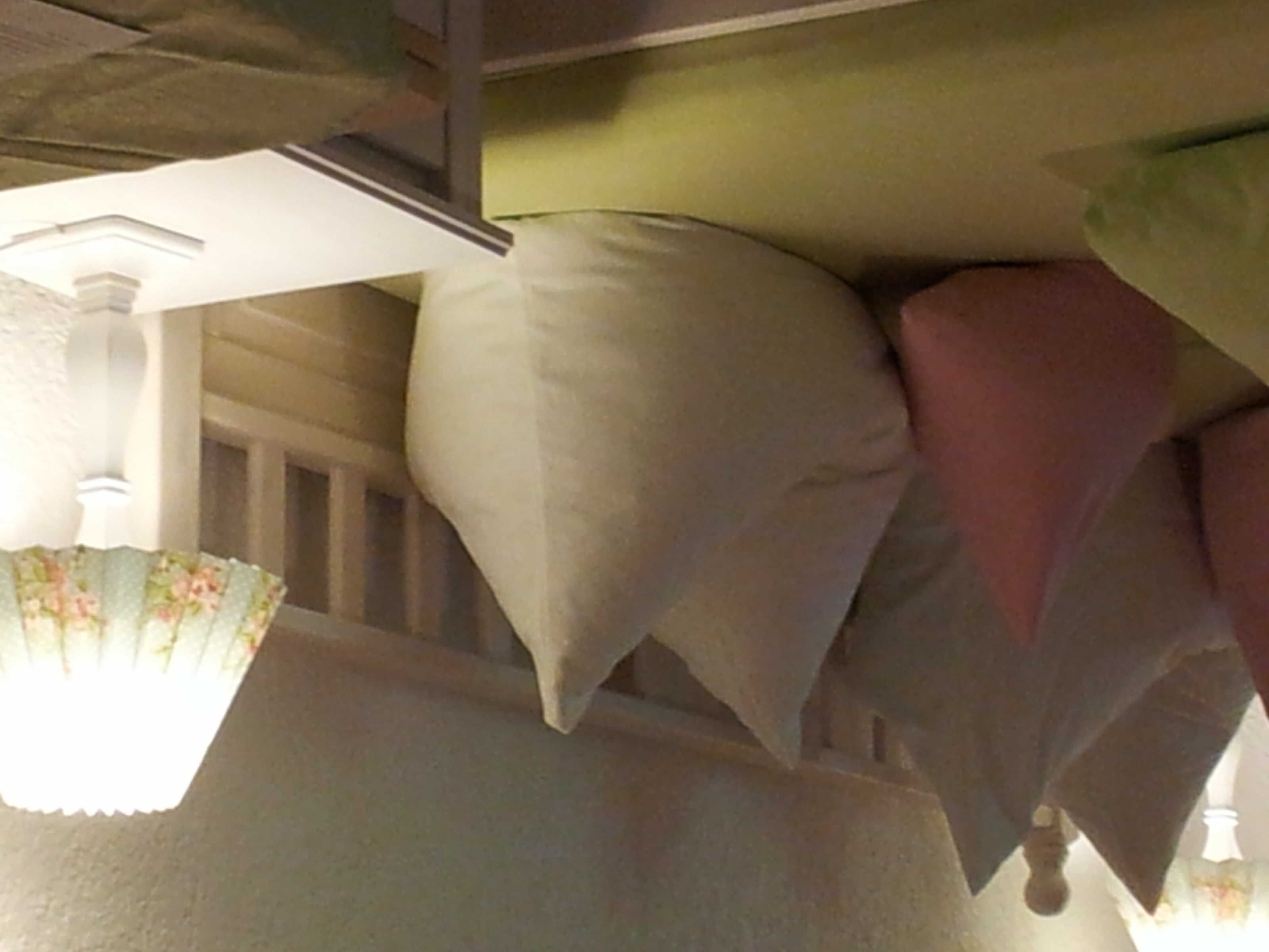 A ceiling with multiple pillows arranged in a decorative pattern.