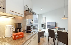 Fridge, stovetop, dishwasher, coffee/tea maker