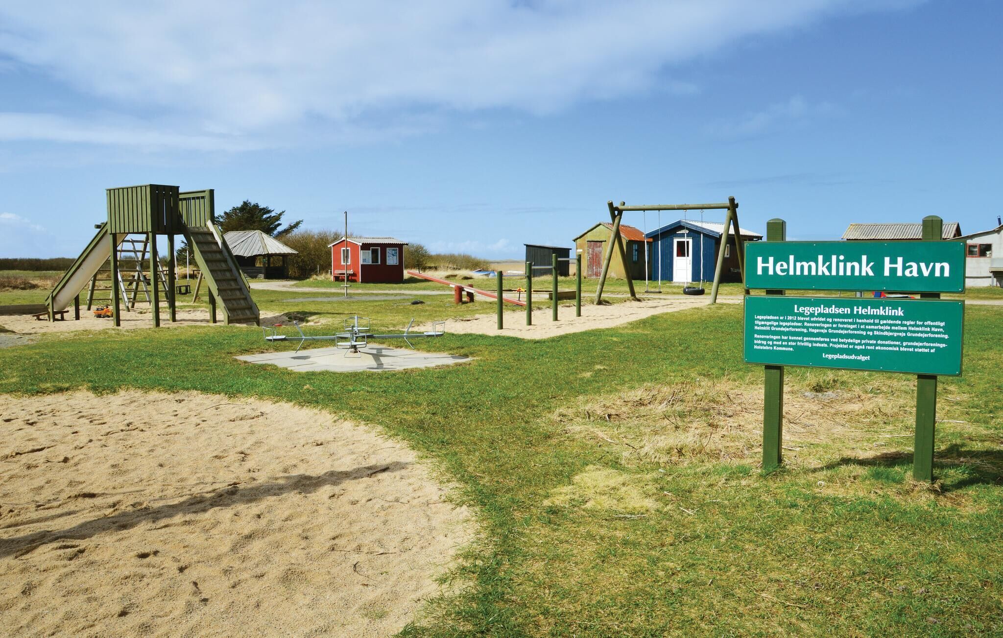 A playground with swings, slides, and a climbing structure.