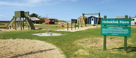 A playground with swings, slides, and a climbing structure.
