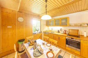 A kitchen with wooden cabinets, a stainless steel sink, and a built-in oven.