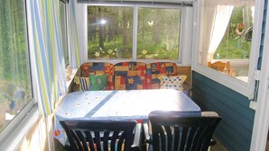 A cozy room with a window seat, a table, and two chairs.