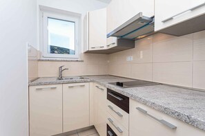 Fridge, microwave, stovetop, coffee/tea maker