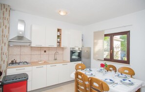 Fridge, stovetop, dishwasher, coffee/tea maker