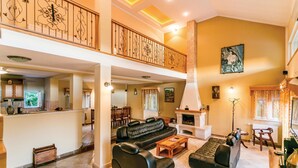 A spacious living area with a high ceiling, a fireplace, and a dining area with a view of the kitchen. - Awesome apartment in Herceg Novi (Herceg Novi)