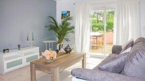 A living room with a wooden coffee table, a grey sofa, a white sideboard, and a potted plant. - Stunning home in Lançon de Provence (Lançon de Provence)