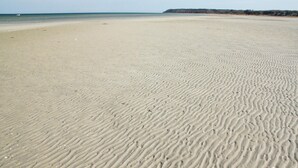 A wide sandy beach with gentle waves and a distant shoreline. - 3 bedroom lovely home in Glesborg (Glesborg)
