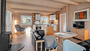 A cozy cabin interior with a living area, kitchen, and dining space. - Beautiful home in Farsø with kitchen (Farsø)
