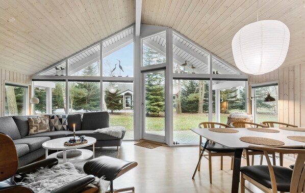 Enjoy expansive views of the surrounding landscape from the large windows in this stylishly designed room.