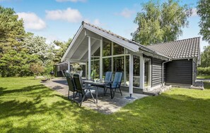 Enjoy dining or socializing in this outdoor seating area with a table and chairs.