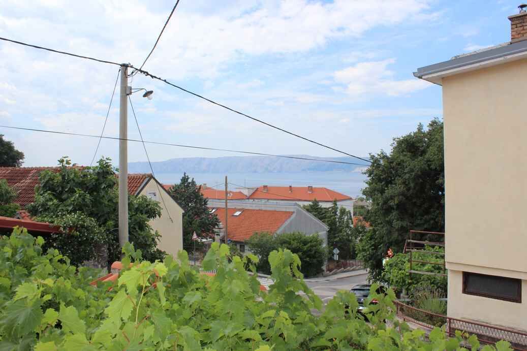A residential area with houses, a utility pole, and a clear view of the mountains in the background.