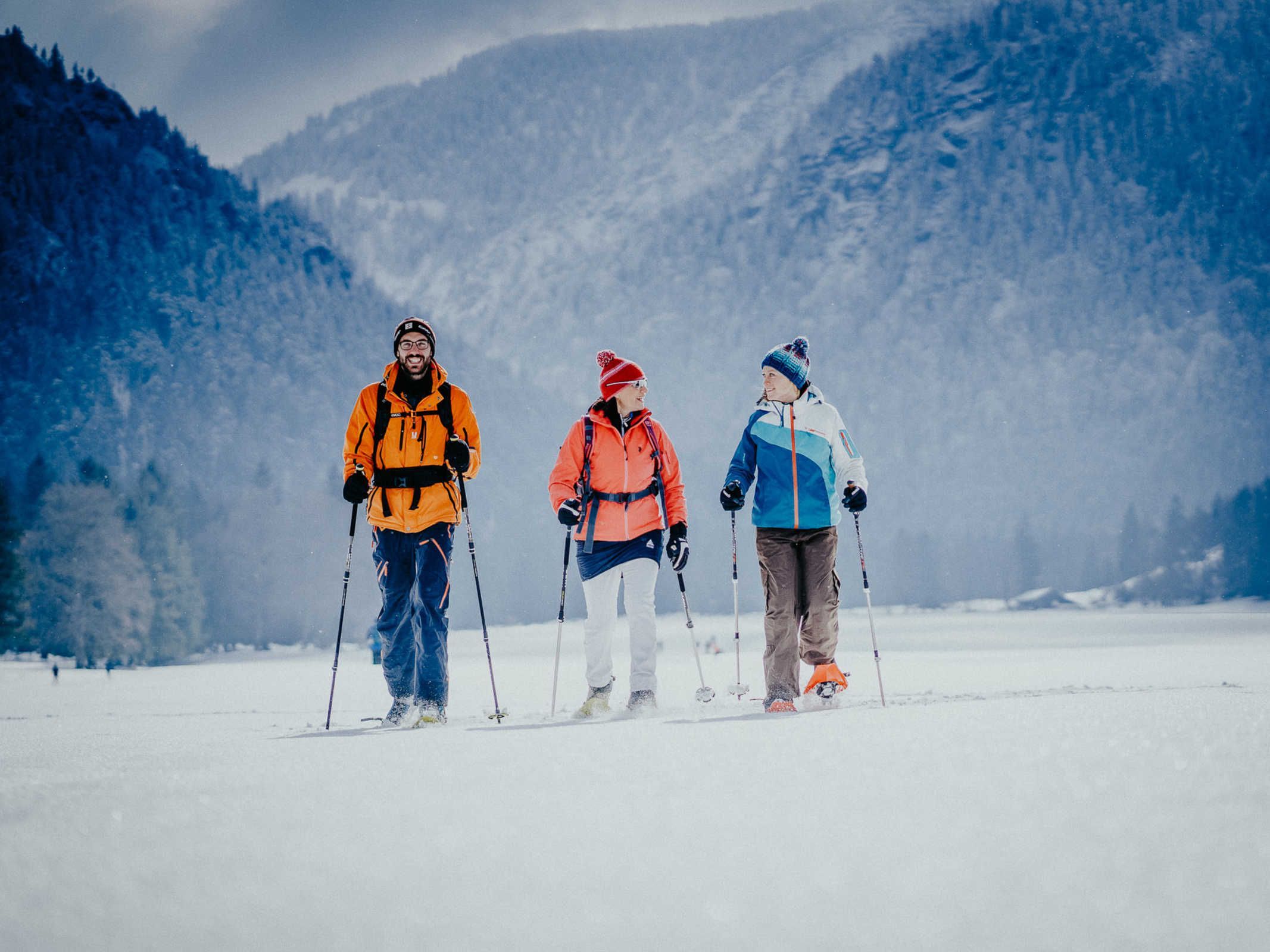 Three people skiing on a snowy mountain.