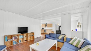 A living room with a television, bookshelf, sofa, and a small table. - Lovely home in Hvide Sande with WiFi (Hvide Sande)