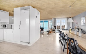 A modern kitchen with white cabinets and a built-in microwave. - Gorgeous home in Harboøre with sauna (Harboøre)